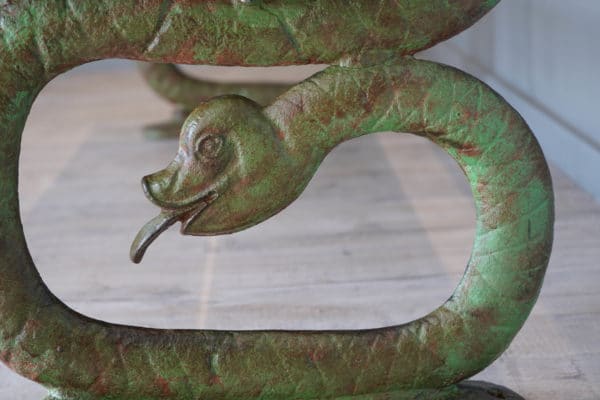 a serpent design cast iron bench
