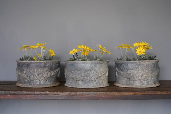 three matching vintage lead plant pots