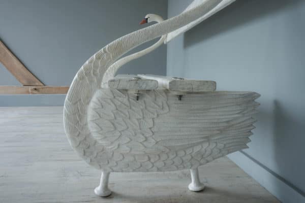 elegant cast iron and wood garden seat in design of a swan