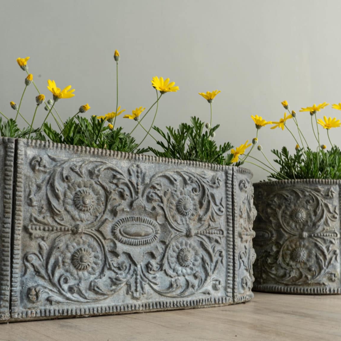 a pair of lead rectangular planters