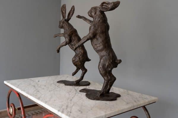 Two boxing hares in bronze