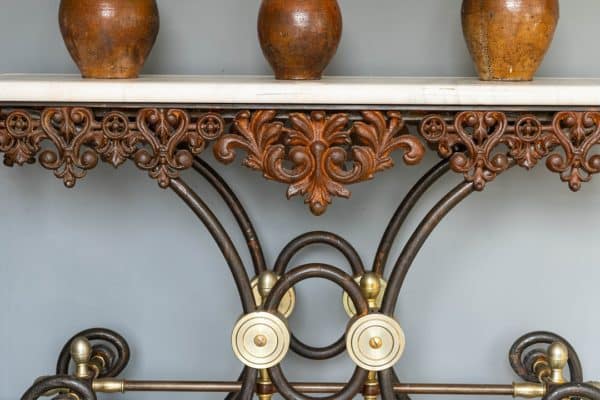 an antique iron and marble topped table
