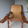 A pair of wooden antique plantation chairs