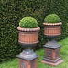 dark antique terracotta garden urns on plinths for sale