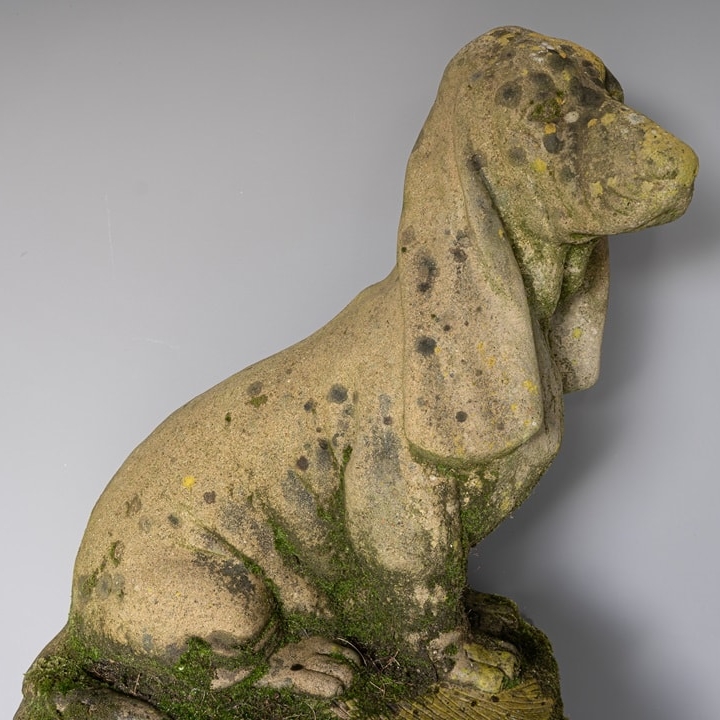 a cast stone decorative garden antique dog statue