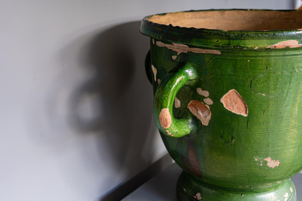 an antique green glazed vase with four handles from France
