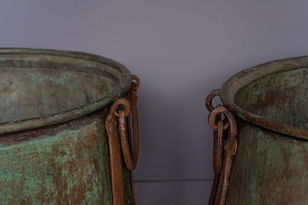 a pair of giant antique copper cauldron