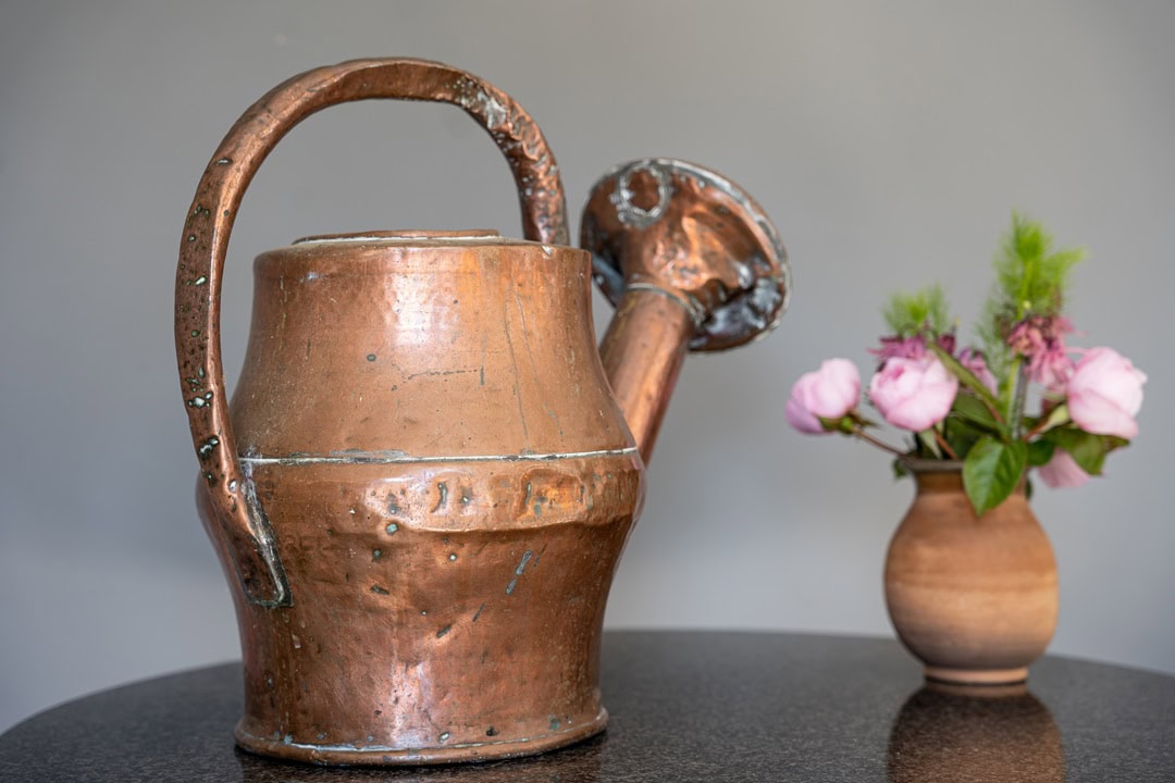 an antique copper watering can
