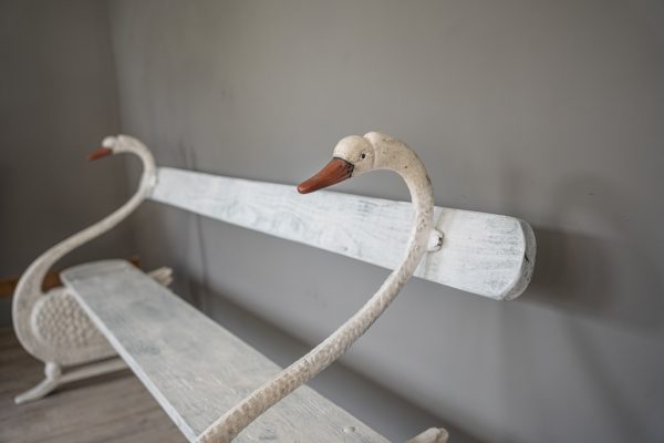 an antique garden swan bench