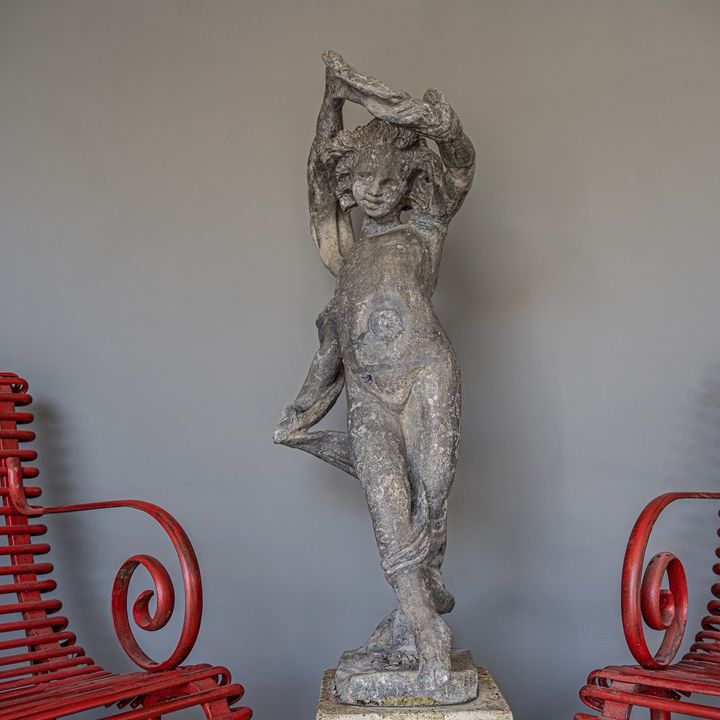 an antique lead garden cherub statue