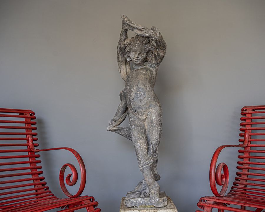 an antique lead garden cherub statue
