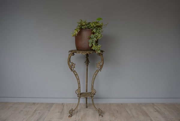 an indoor antique plant stand