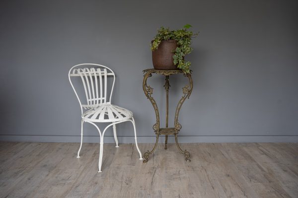 an indoor metal antique plant stand
