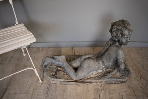 a garden antique statue of a cherub or baby