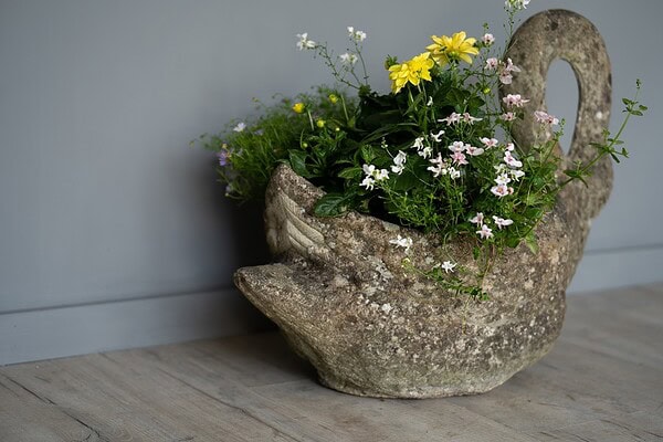 an antique swan planter
