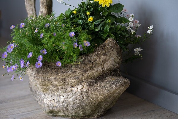 an antique swan planter