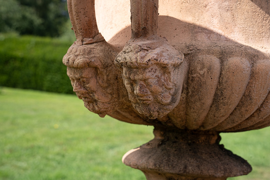 a pair of decorative vintage garden urns on plinths for sale