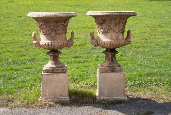 a pair of garden urns on plinths for sale