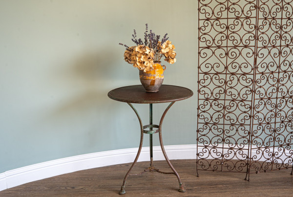 an antique garden folding iron screen