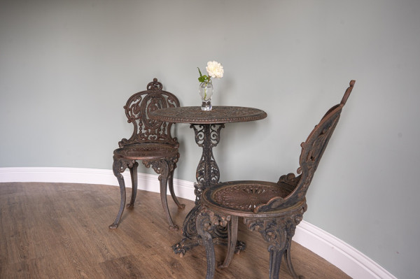 antique garden table and two chairs in the style of Coalbrookdale