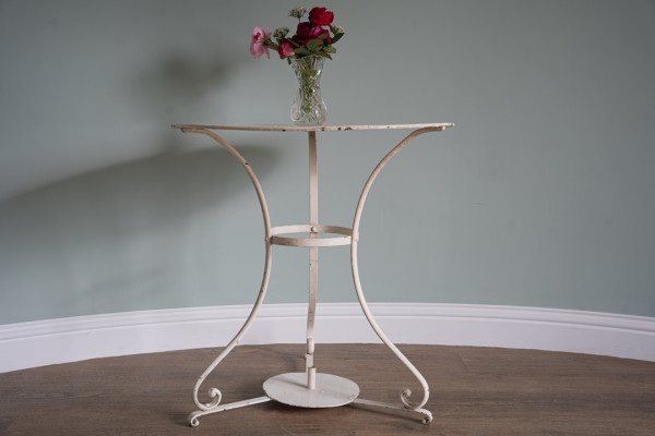a three legged vintage garden dining table for two persons