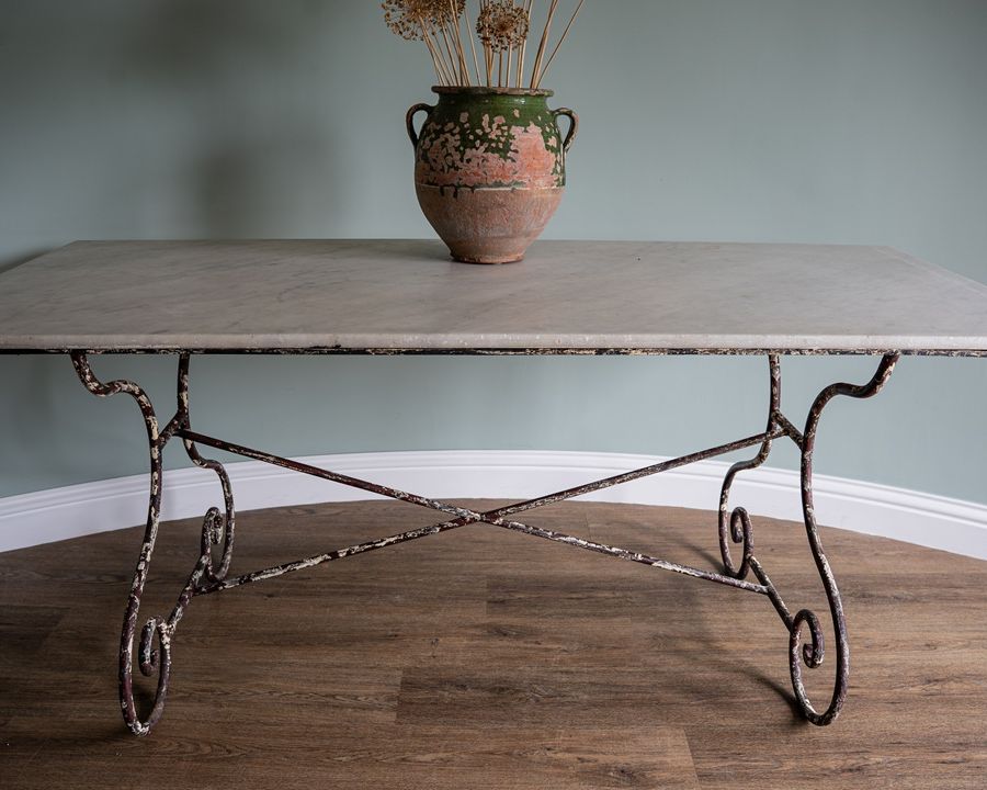 an iron legged marble topped antique garden table
