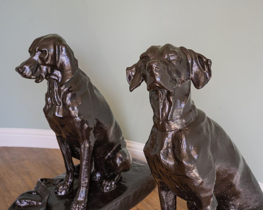 restored pair of cast iron garden dog statues