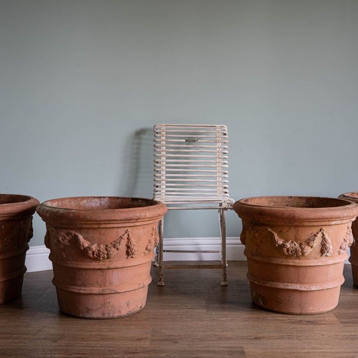 a set of vintage large terracotta plant pots