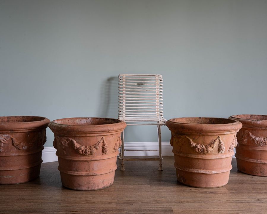 a set of vintage large terracotta plant pots