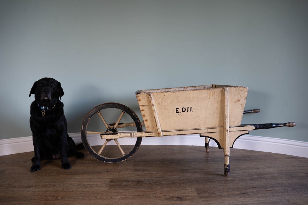 a wooden antique wheelbarrow