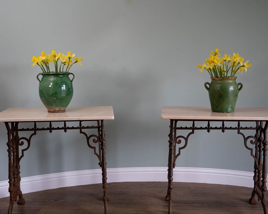 a cast iron pair of tables