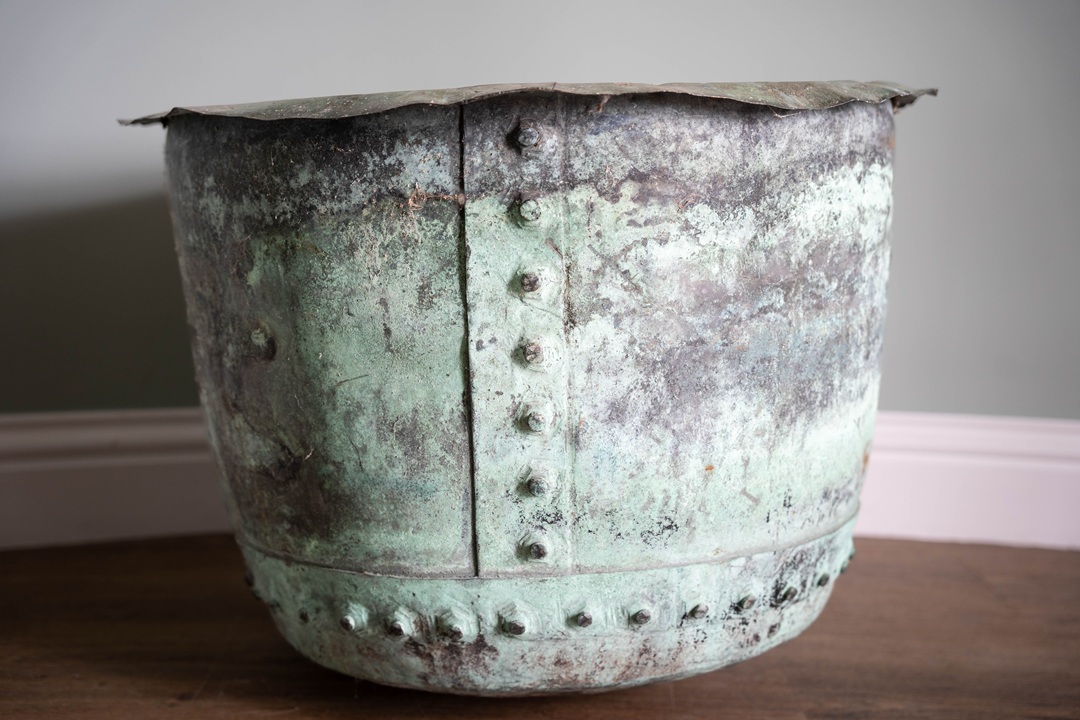 a very large antique copper pot