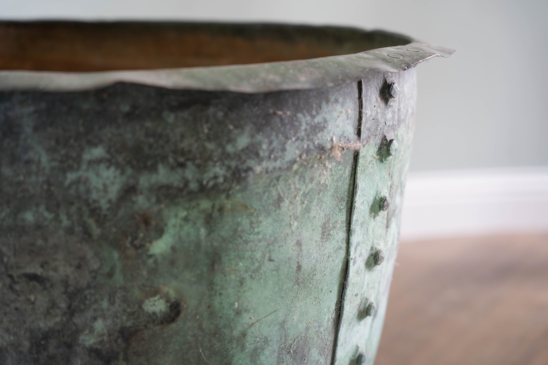 an antique copper planter