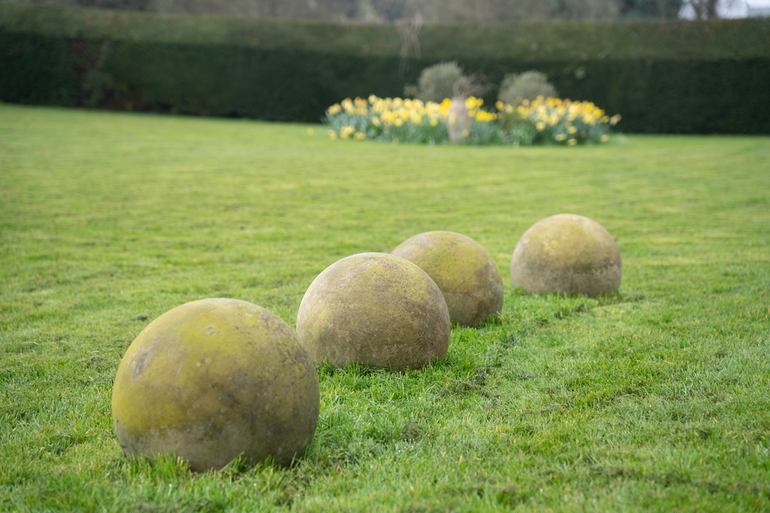 four stone garden balls