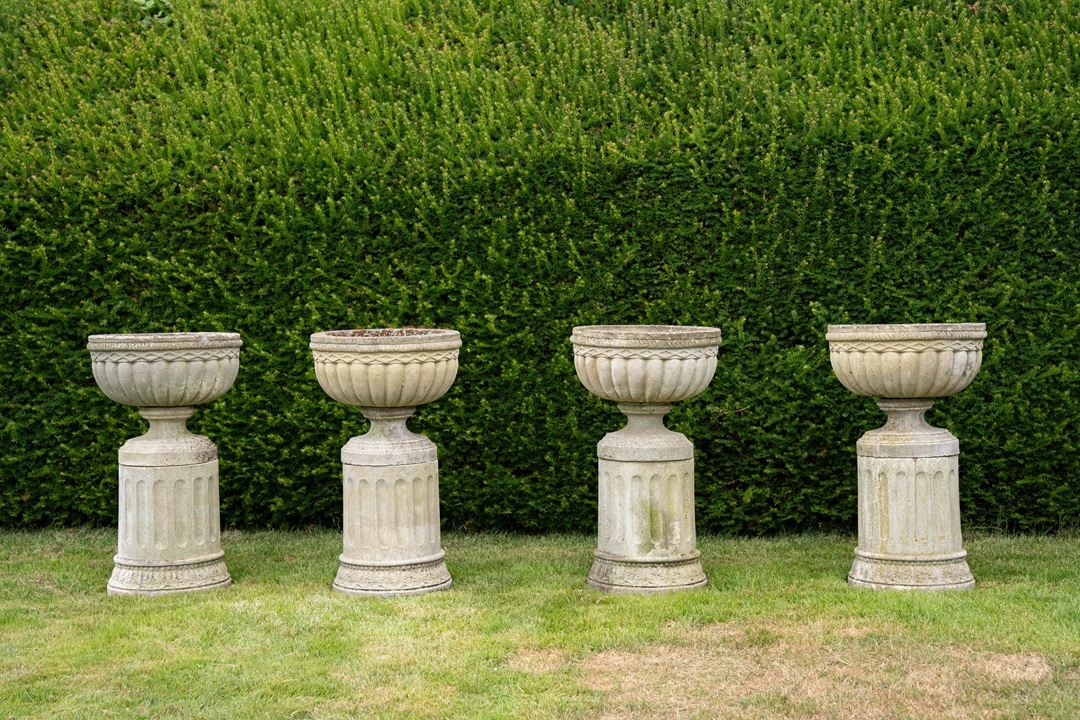 set of four vintage garden urns on plinths