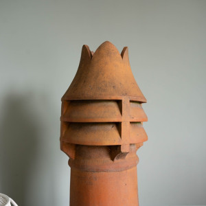 a crown topped antique chimney pot