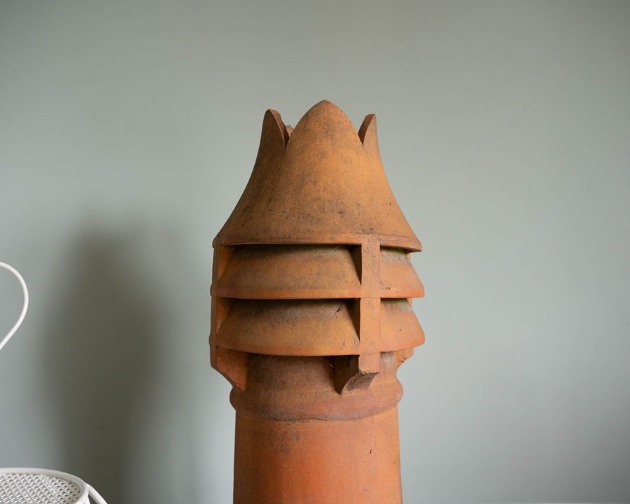 a crown topped antique chimney pot