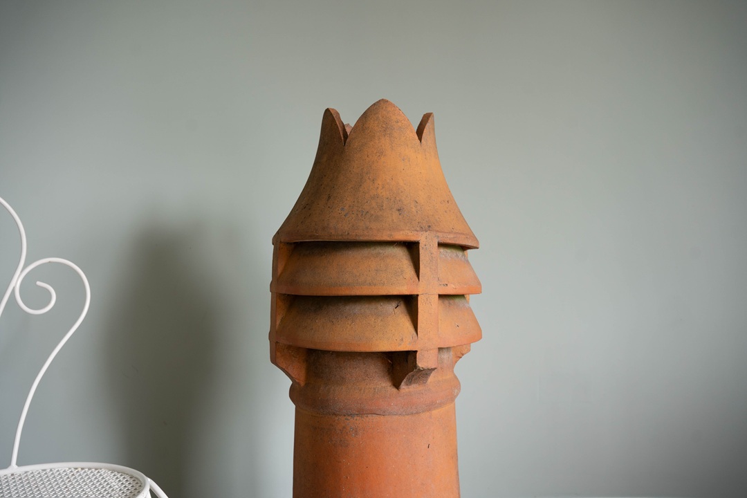 a crown topped antique chimney pot