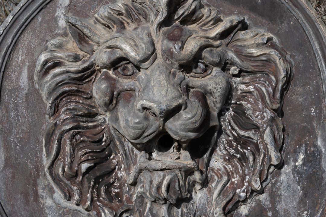 the water cascades from the lions mouth into the semi circular lead cistern below