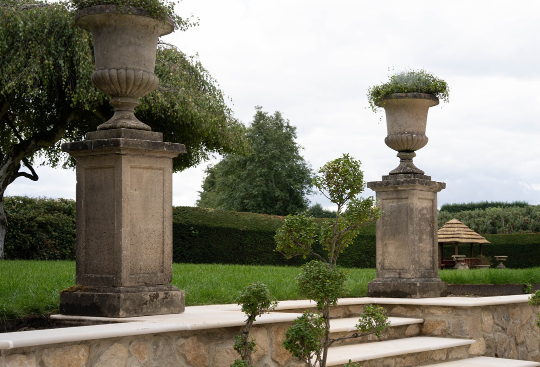 pair antique garden urns on plinths
